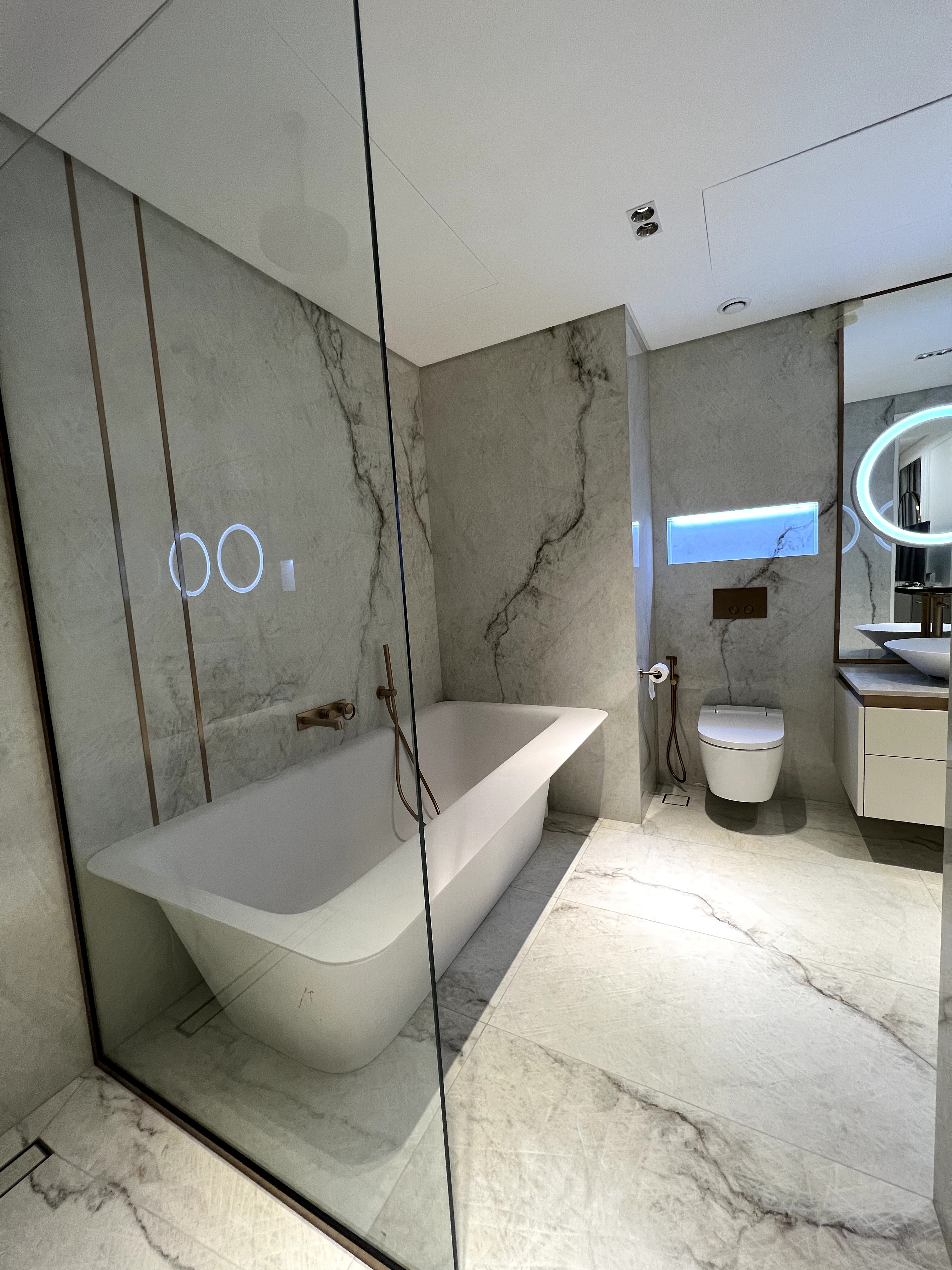 Luxury bathroom with freestanding bathtub and grey marble walls