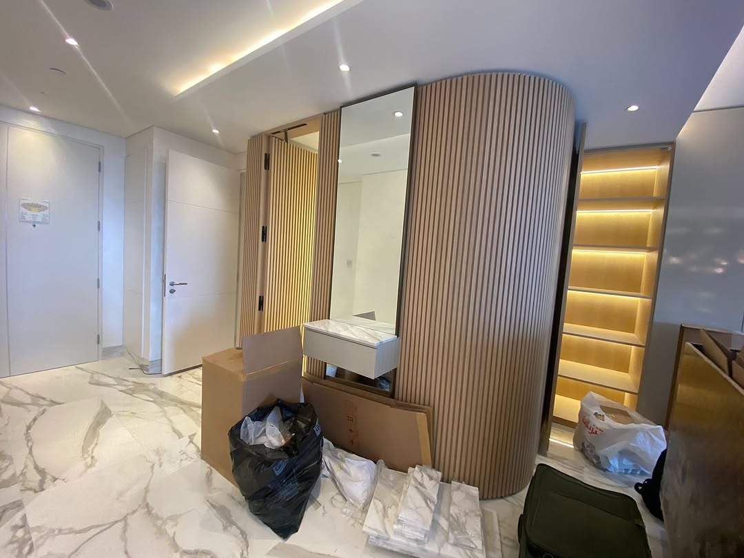 Modern hallway with curved wood slatted wall and marble flooring
