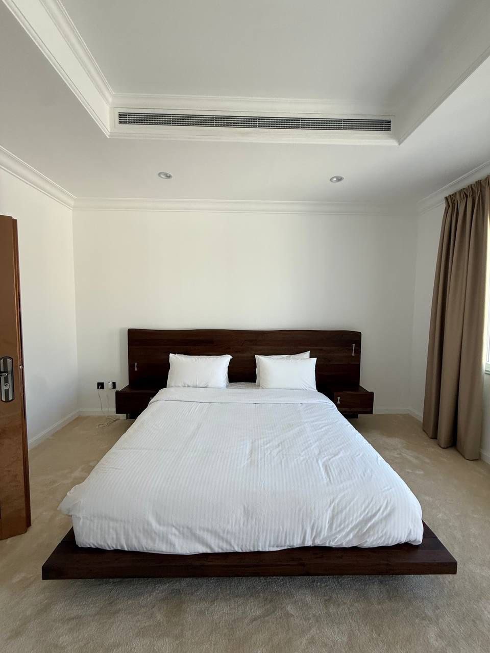 Minimalist bedroom with dark wood platform bed