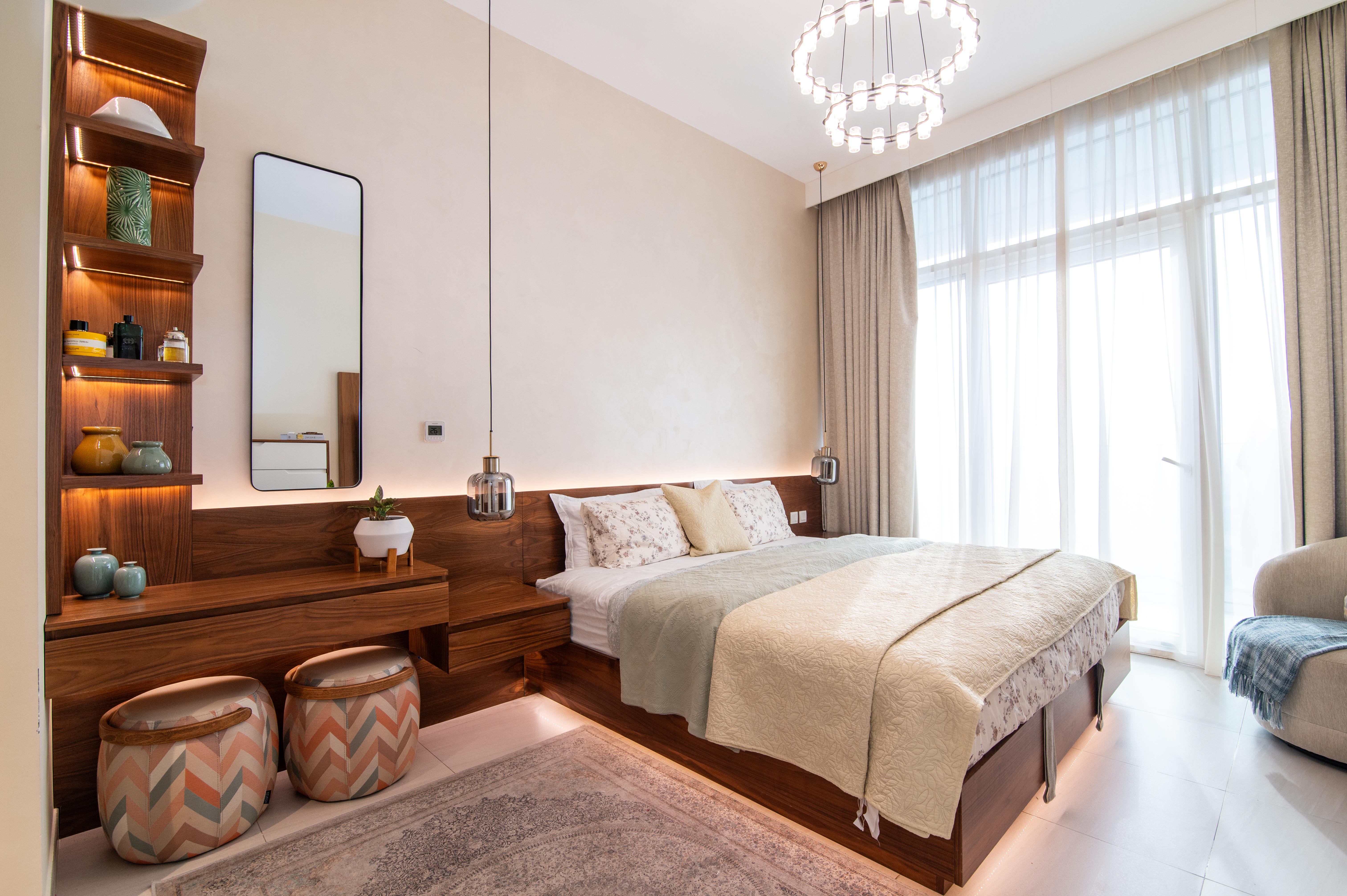 Bedroom with bespoke walnut headboard, marble dresser and pendant lighting