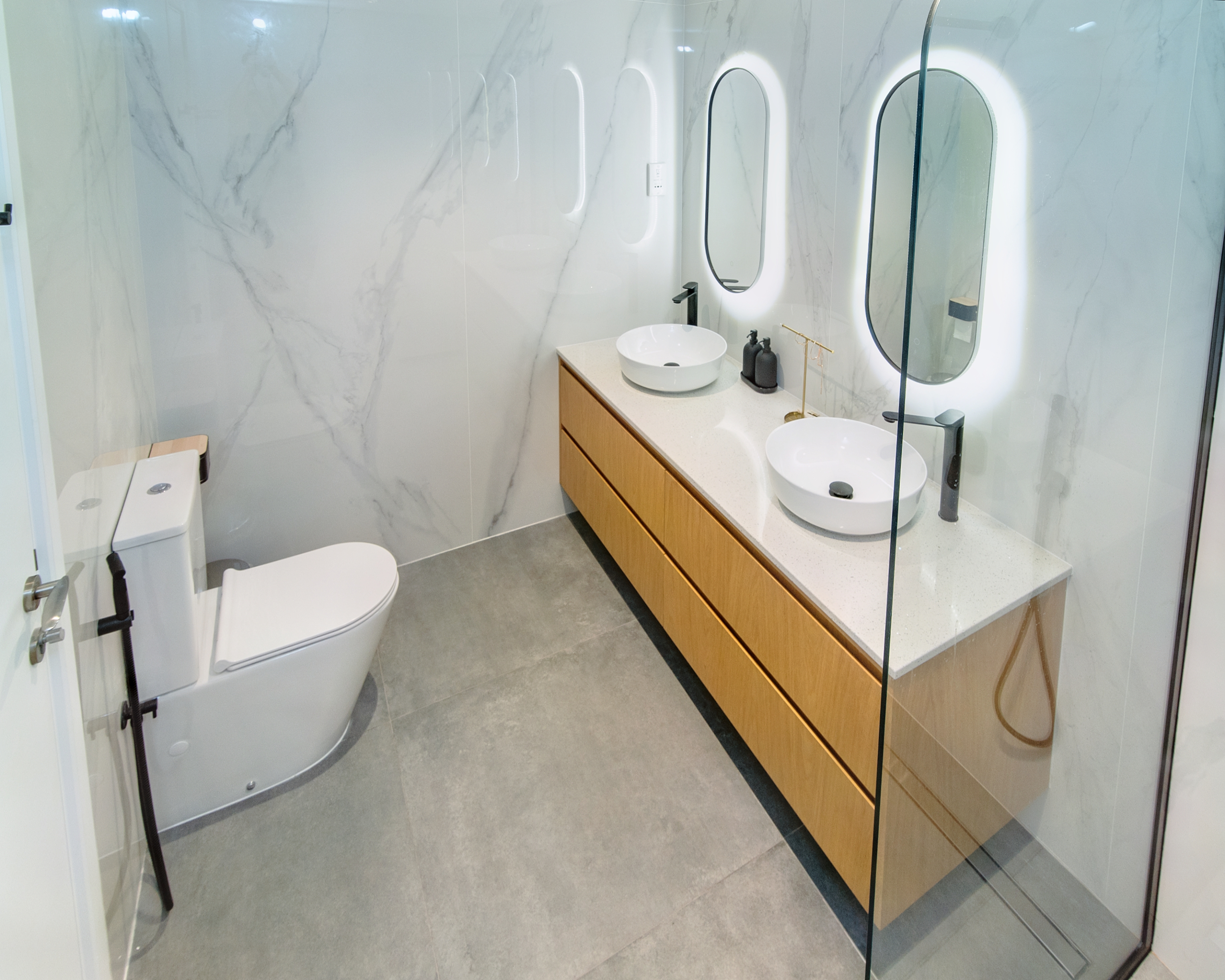 Bathroom with tiled shower and vanity