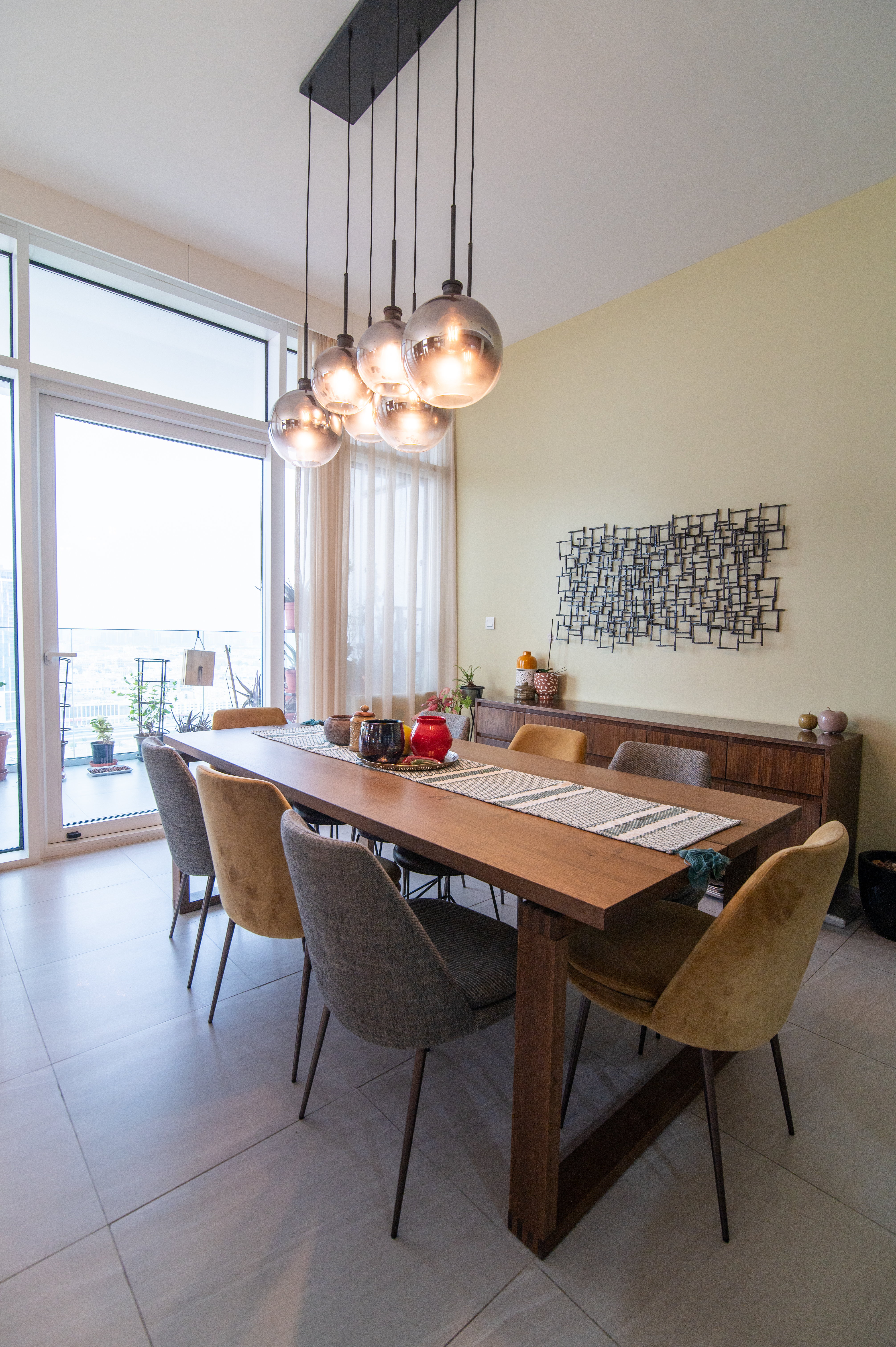 Open-plan dining with floor-to-ceiling windows and skyline view