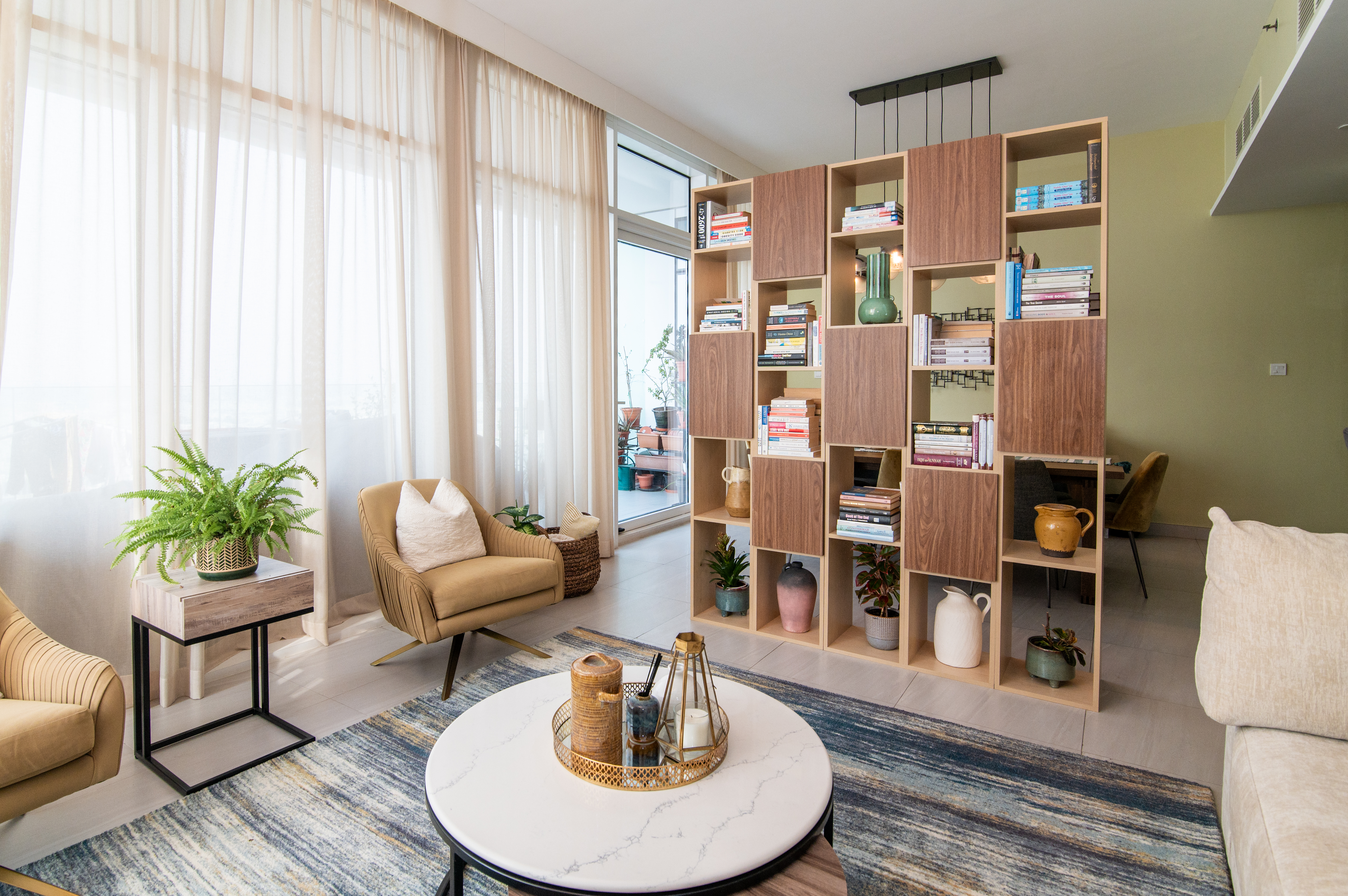 Cream sectional with bespoke bookshelf and accent armchair