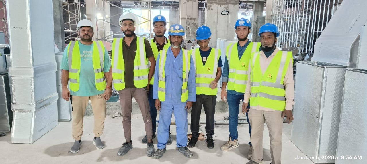In-house construction team on active fitout site wearing hard hats and high-vis vests