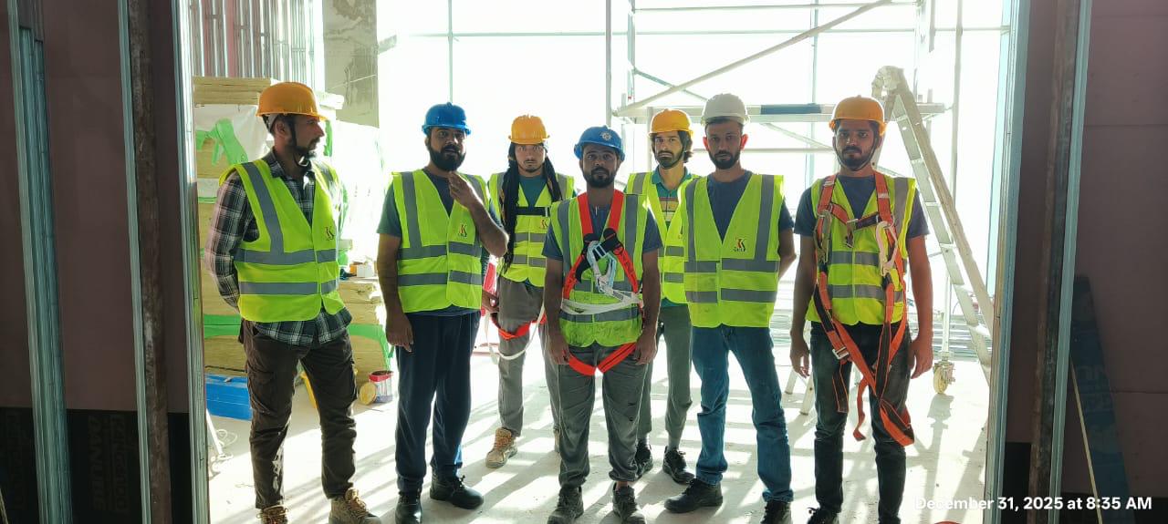 Construction team in hard hats and safety harnesses on fitout site