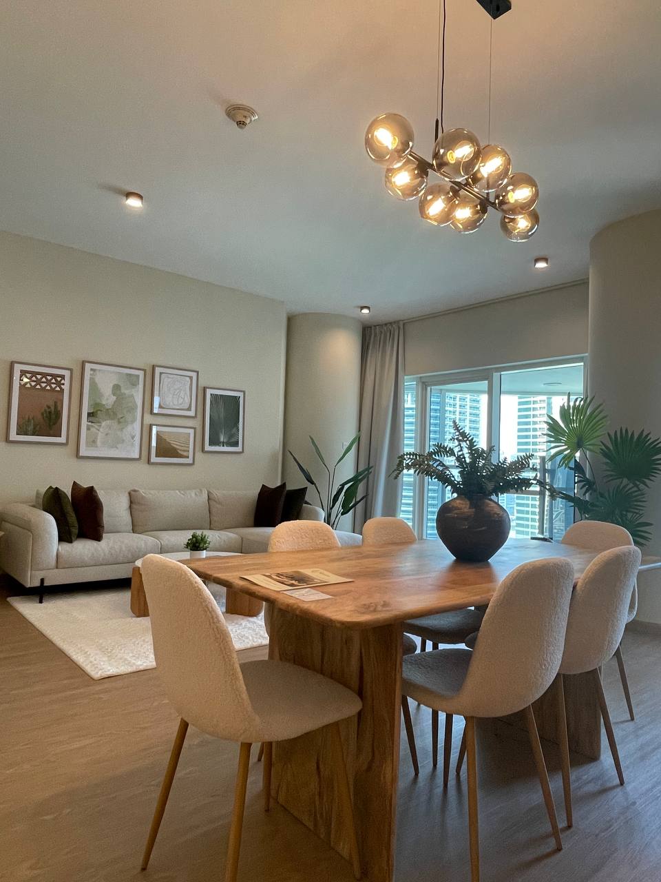 Beautifully furnished open-plan living and dining area with modern organic design
