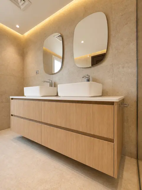 A freshly renovated modern bathroom features a floating light wood double — Just Right Interior Decoration LLC, Dubai Marina