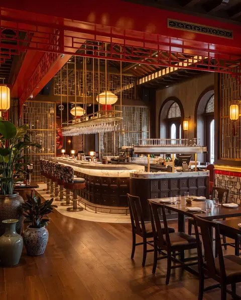 A luxurious and elegantly furnished restaurant interior showcases a prominent bar with a white — APEX STEEL WORKS L.L.C