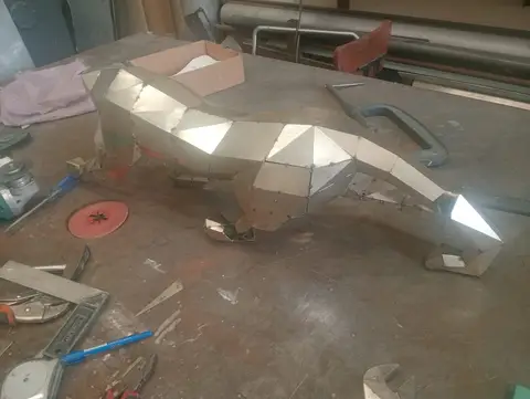A striking geometric metal sculpture of an animal, possibly a fox or wolf, is meticulously crafted — APEX STEEL WORKS L.L.C