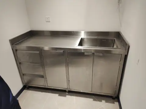 A newly installed stainless steel utility counter with an integrated single-bowl sink, three — APEX STEEL WORKS L.L.C, UAE