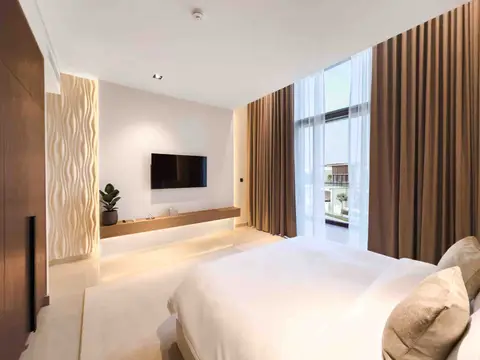Minimalist bedroom with wall-mounted TV and LED lighting