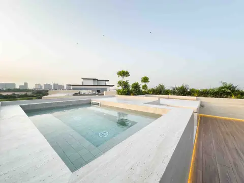 Rooftop pool and lounge area with travertine stone