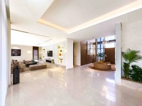 Polished light marble flooring, dark wood paneling, and built-in display shelves define — Tasaddaq Mughal Technical Services