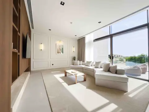 A modern living room featuring a curved sectional sofa, a minimalist coffee table, and — Tasaddaq Mughal Technical Services