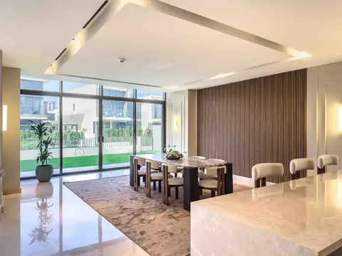 A modern dining area featuring a dark marble table, wooden slat accent wall, and — Tasaddaq Mughal Technical Services