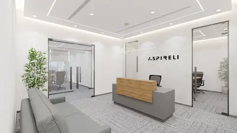 A modern office reception area features a grey and wood reception desk, a grey — INTERIOXPERT TECHNICAL SERVICES CO. L.L.C