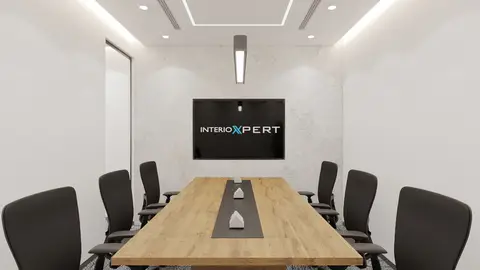A modern meeting room features a long wooden conference table, ergonomic black — INTERIOXPERT TECHNICAL SERVICES CO. L.L.C