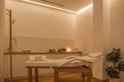 A serene beauty treatment room features an adjustable white treatment bed — CRAFTY CLARE DECORATION DESIGN L.L.C, Dubai