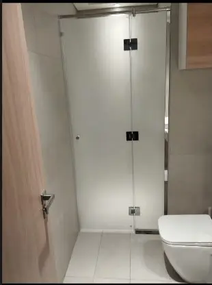 Frosted glass shower enclosure with chrome hardware