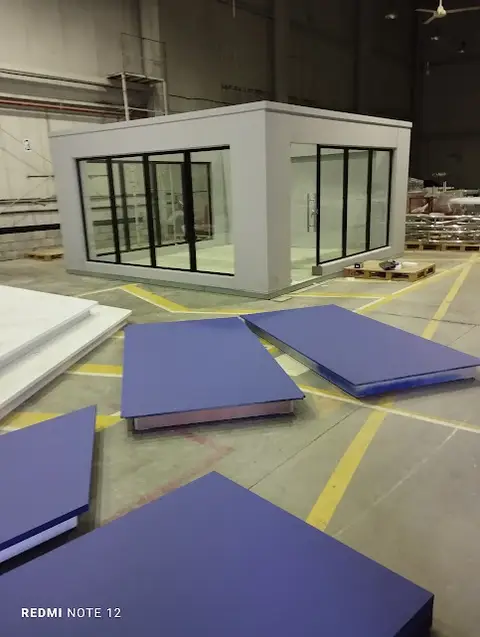 Glass partition office installation in warehouse