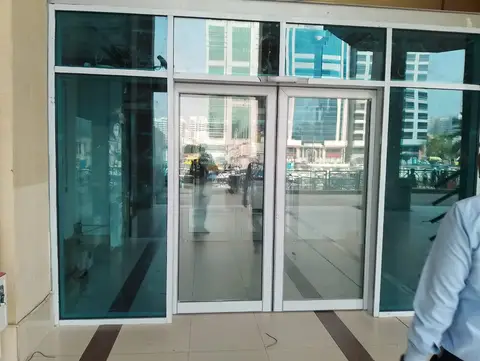 Commercial glass entrance with blue-tinted windows