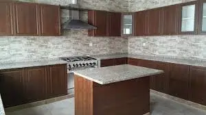 Modern kitchen with dark brown cabinets and island