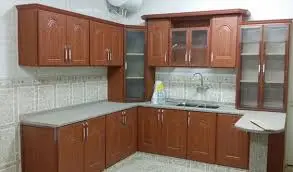 Renovated kitchen with wooden cabinets and grey countertop