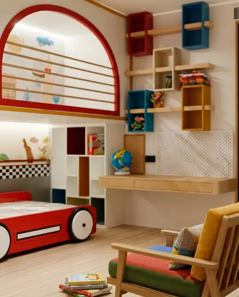 Children's bedroom with red car bed and wooden desk