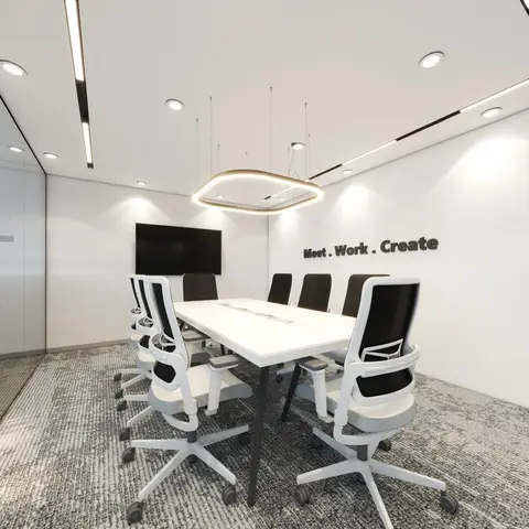 This bright and modern corporate meeting room features a large white conference table surrounded by ergonomic white and 