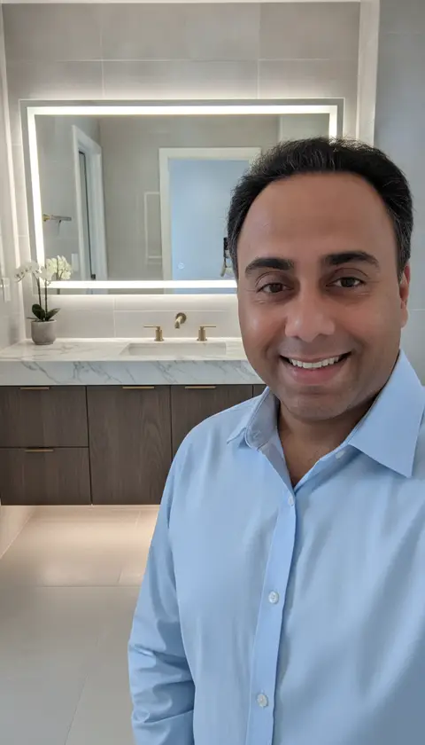 A smiling man in a light blue shirt captures a selfie, showcasing a — Just Right Interior Decoration LLC, Dubai Marina