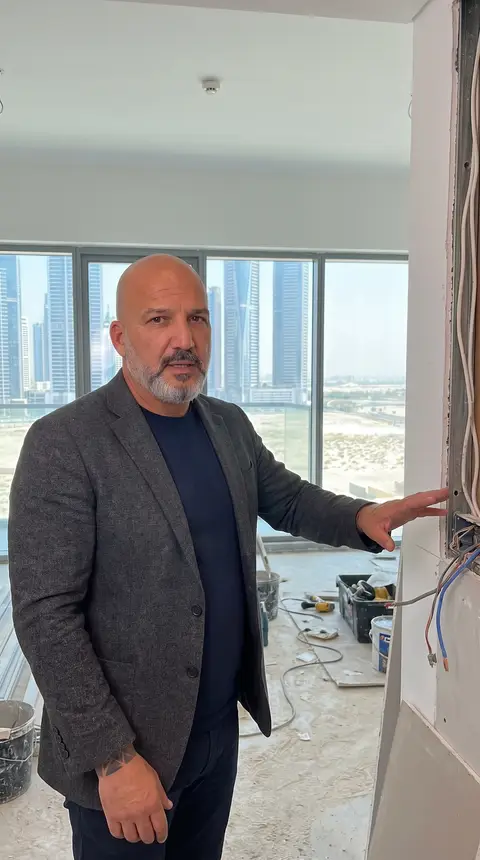 High-rise apartment fit-out in progress, showing exposed electrical wiring within a partially — Chadi Baaklini, Dubai