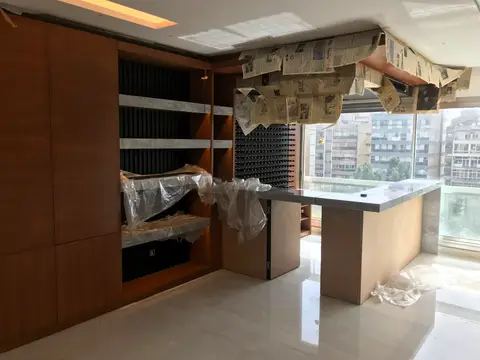 A modern interior space under renovation, featuring a custom built-in wooden shelving unit with — Chadi Baaklini, Dubai