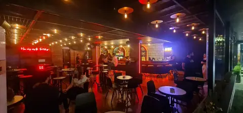 This vibrant, wide-angle shot captures a lively bar and lounge interior, featuring a mix of — Chadi Baaklini, Dubai