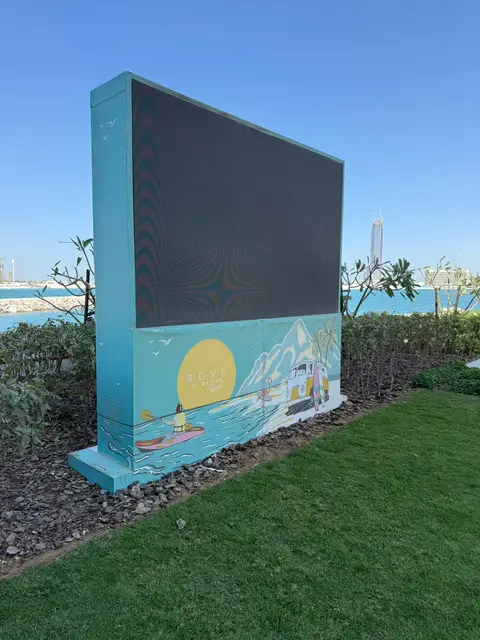 A large outdoor LED screen with a vibrant illustrative — MINGASH ENGRAVING & ORNAMENTATION WORKS EST., Al Marjan Island