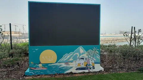 A vibrant outdoor digital display features a beach-themed — MINGASH ENGRAVING & ORNAMENTATION WORKS EST., Al Marjan Island