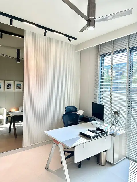 A bright and modern home office features a white minimalist desk with — Lacasa Line Decoration Design And Fitout LLC, Dubai