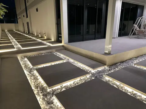 A beautifully illuminated modern exterior pathway features large — Lacasa Line Decoration Design And Fitout LLC, Dubai