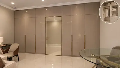 A full-height glossy beige built-in wardrobe system with gold handles — Lacasa Line Decoration Design & Fit-Out L.L.C, Dubai