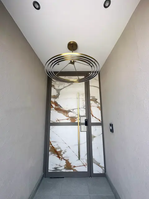 Finished villa entryway with marble door and gold detailing