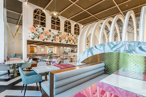 A modern restaurant interior in Dubai features a floral wall installation, arched partitions with — Muhammed  Gani