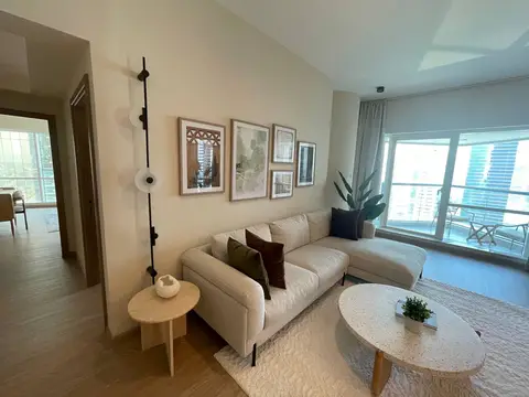 A bright and inviting modern living room features a cream sectional sofa, a terrazzo — ROUND TRIANGLE DECORATION CO. L.L.C