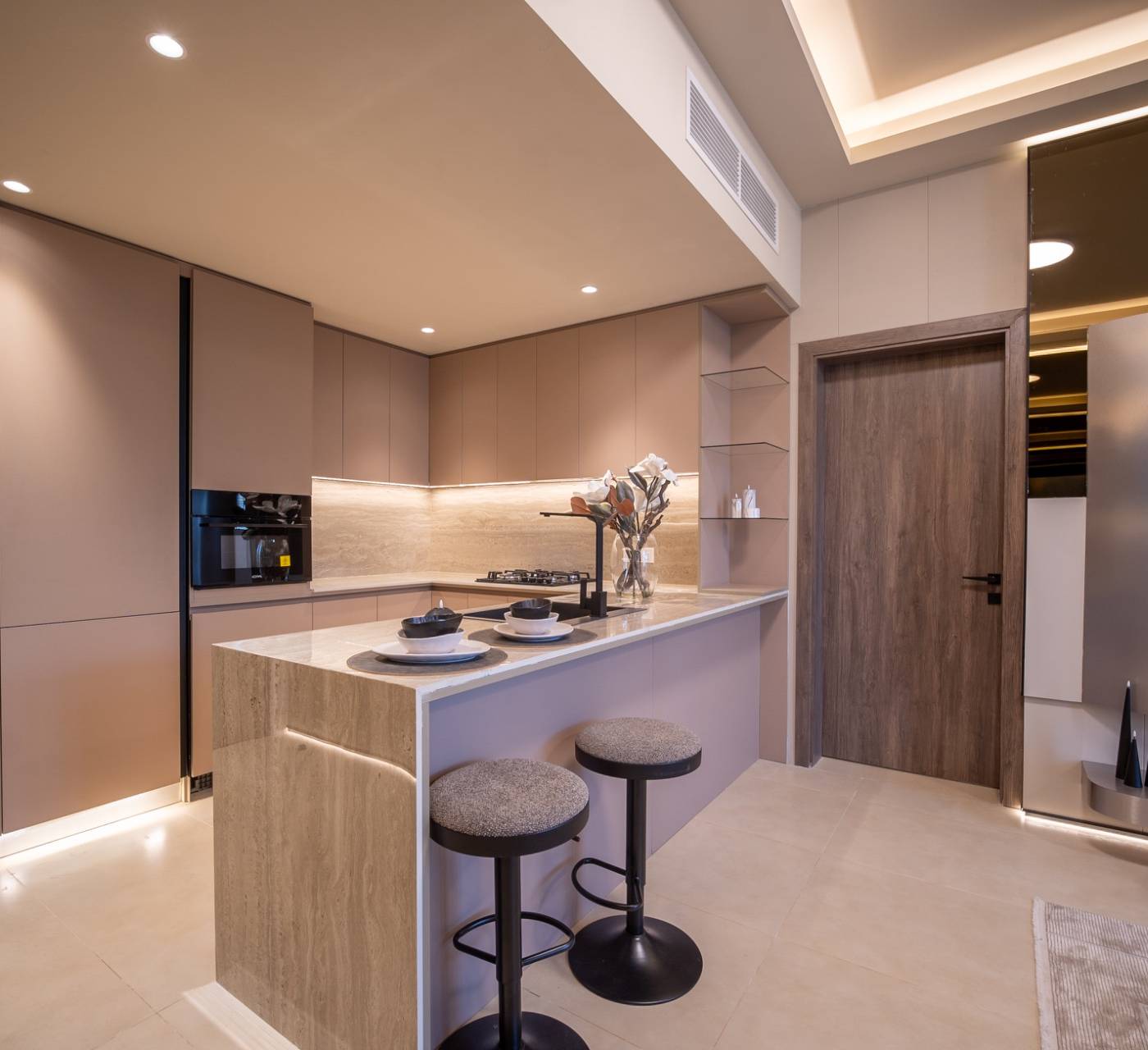 Modern minimalist kitchen with marble island and integrated appliances, part of a villa fit-out in Dubai by Lacasa Line.