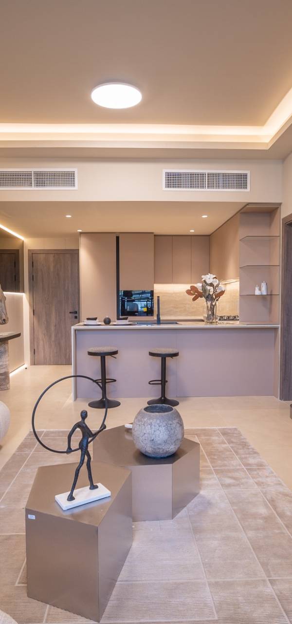 Open plan living room with cream sofa and hexagonal tables