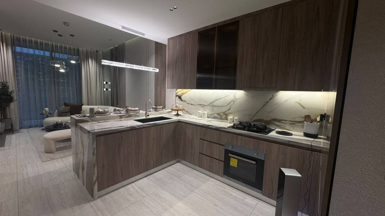 Custom kitchen fitout Dubai — dark walnut cabinetry with marble backsplash