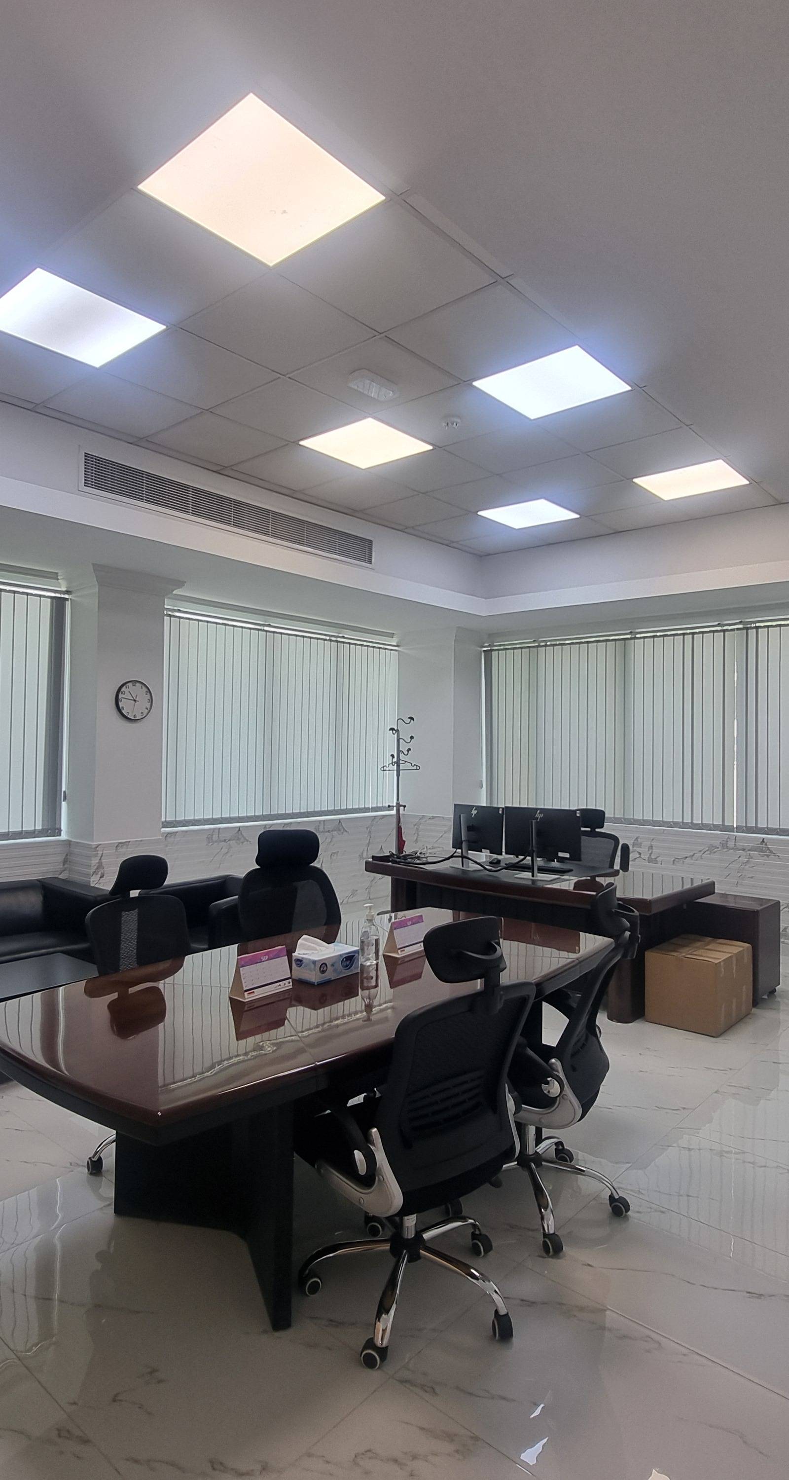 Executive office fit-out with dark wood conference table and marble floor