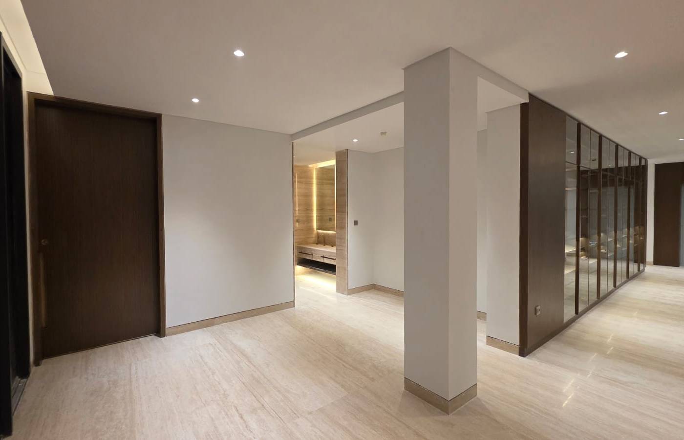 Marble hallway with dark wood doors and glass display cabinets