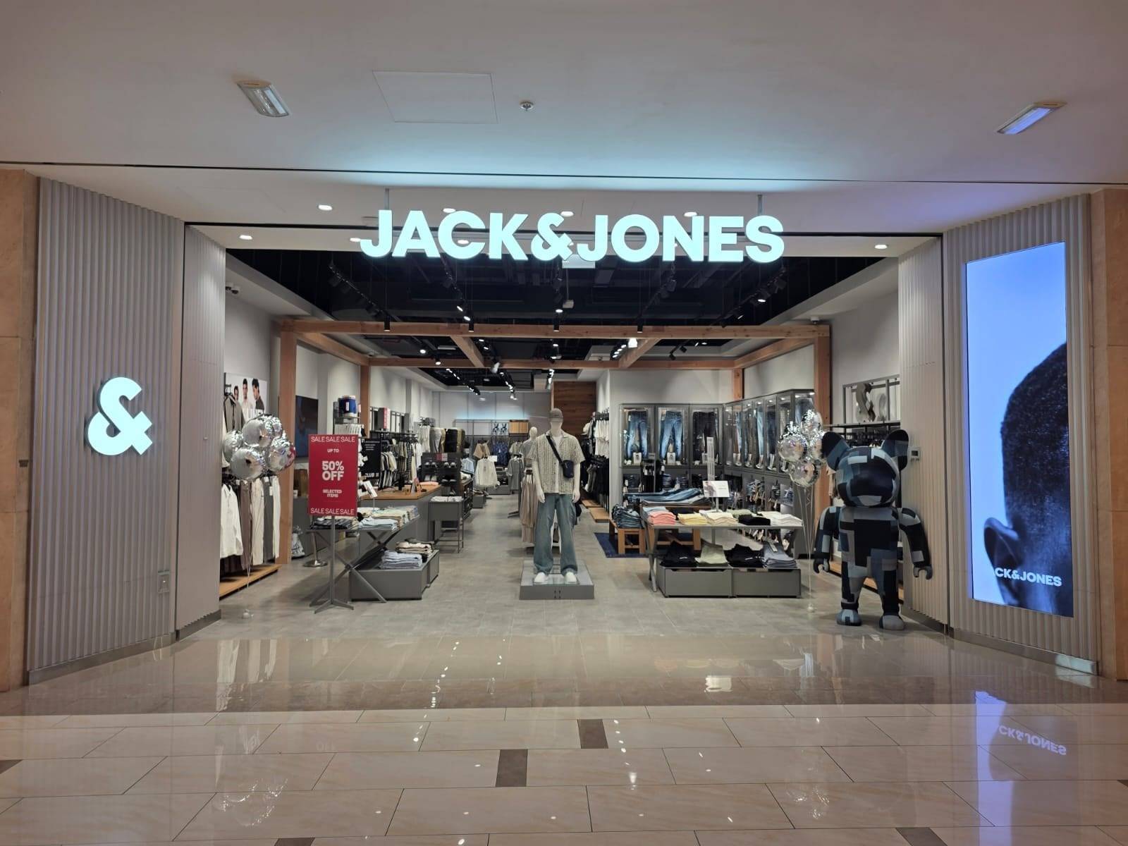 Brightly lit commercial interior with illuminated branding and displays