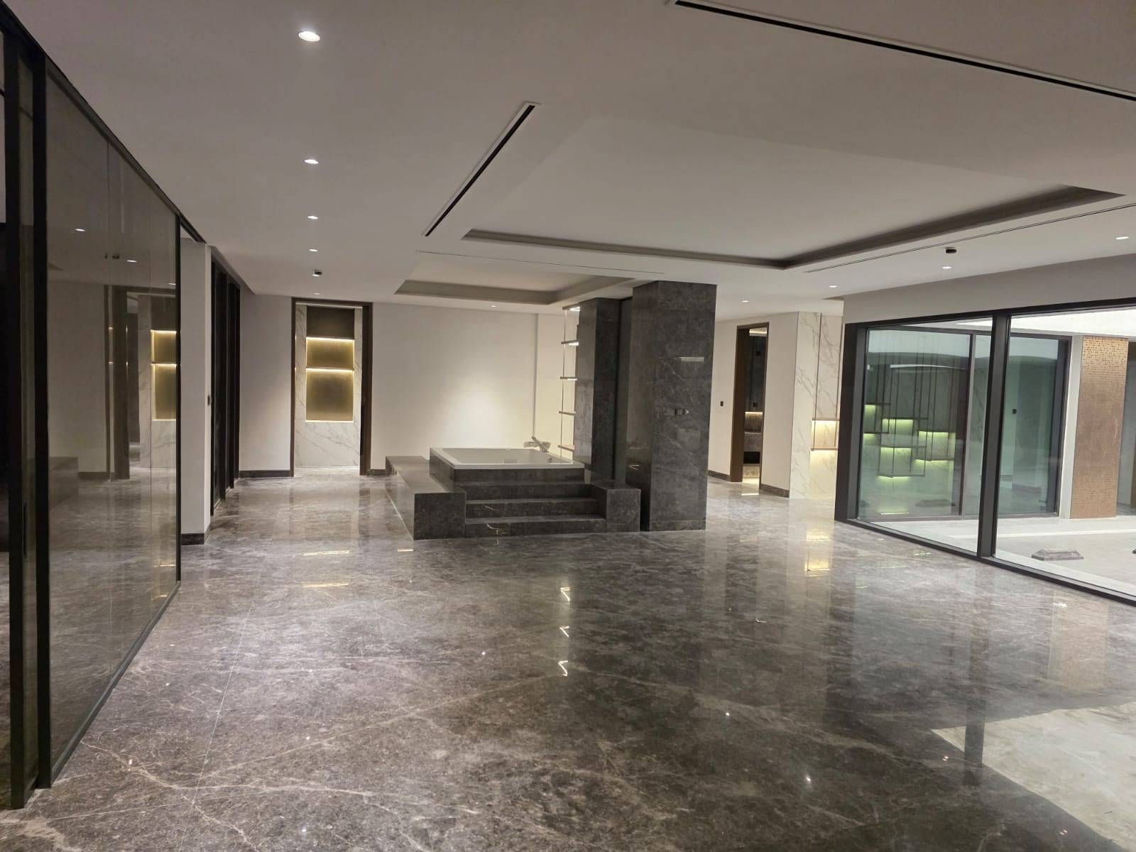 Freshly renovated interior space with polished dark marble flooring