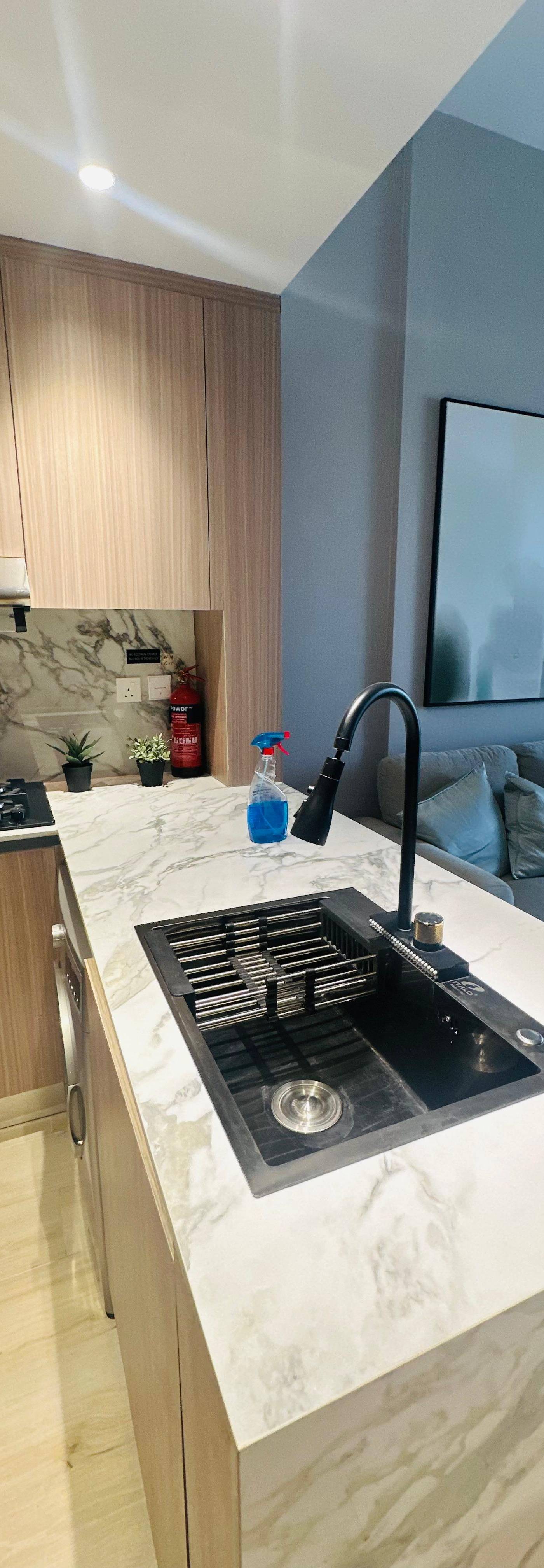 Open kitchen with white marble island, built by CLARE