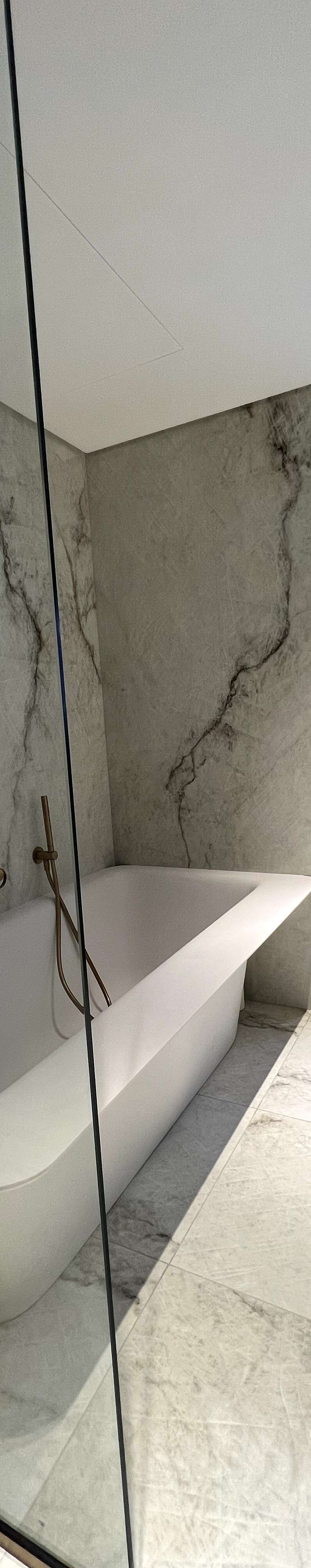 Modern bathroom with freestanding bathtub and marble